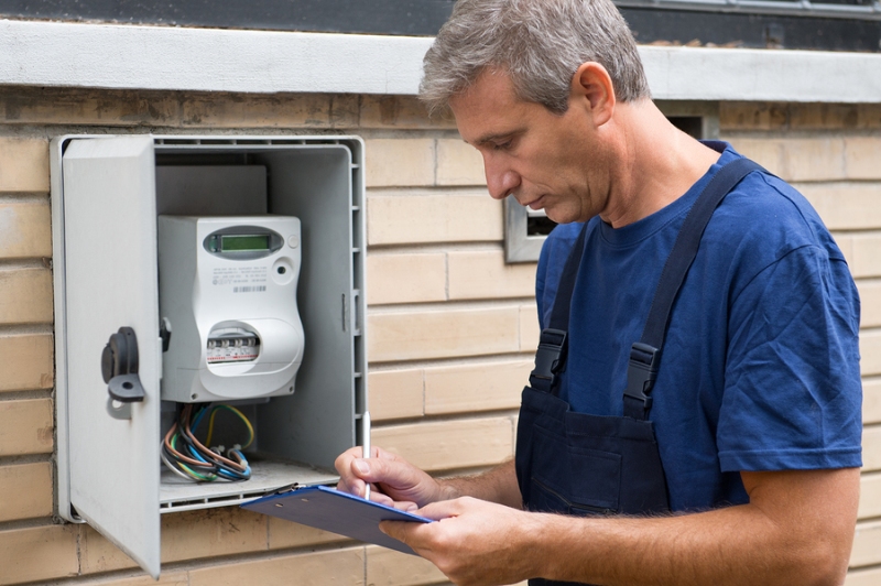An electrician conducting an electrical safety inspection