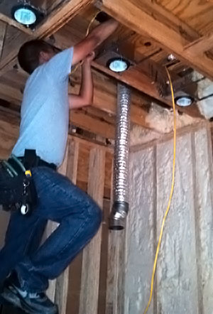 A man installing lights in McKinney, Texas