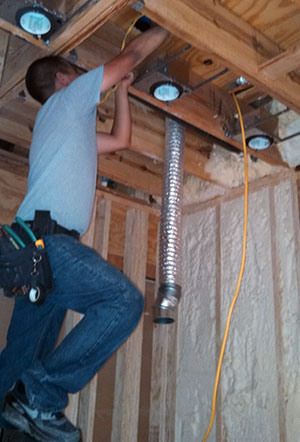 A electrician installing lights 